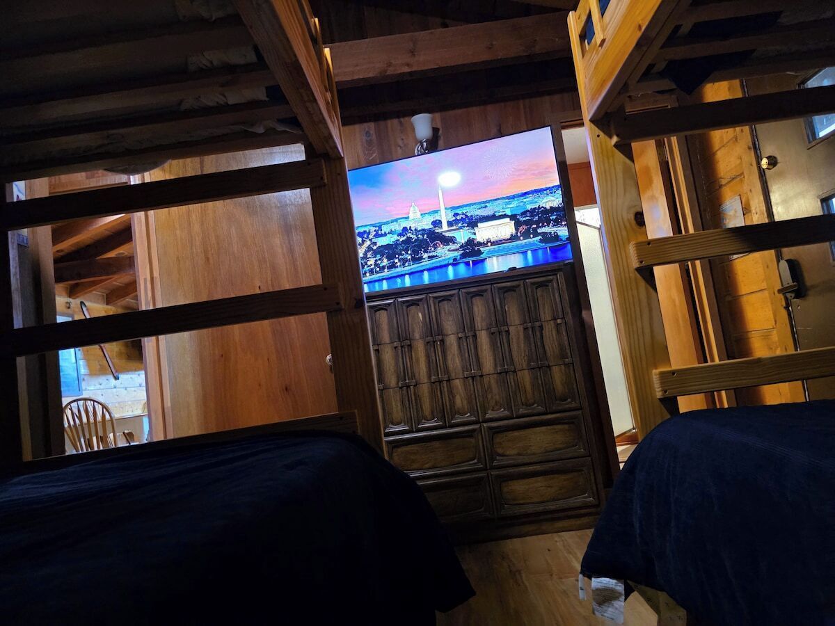 Bunk room with a row of single beds for extra sleepers.