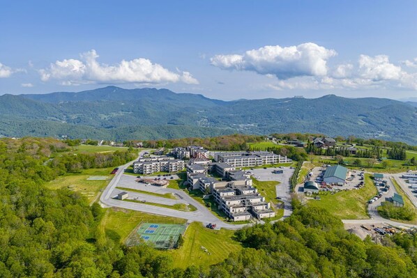 An aerial view of a residential area with multiple buildings, roads, and green spaces. - Cozy 1-bedroom condo in BEECH MOUNTAIN/Hike/Bike/Pool/Raft/Tennis/Pickleball (Beech Mountain)
