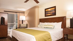 A hotel room with a large bed, a desk, a chair, a TV, and a window with curtains. - Spacious 2-BR/2-bath suite with full kitchen & living room, minutes from beach (Honolulu)
