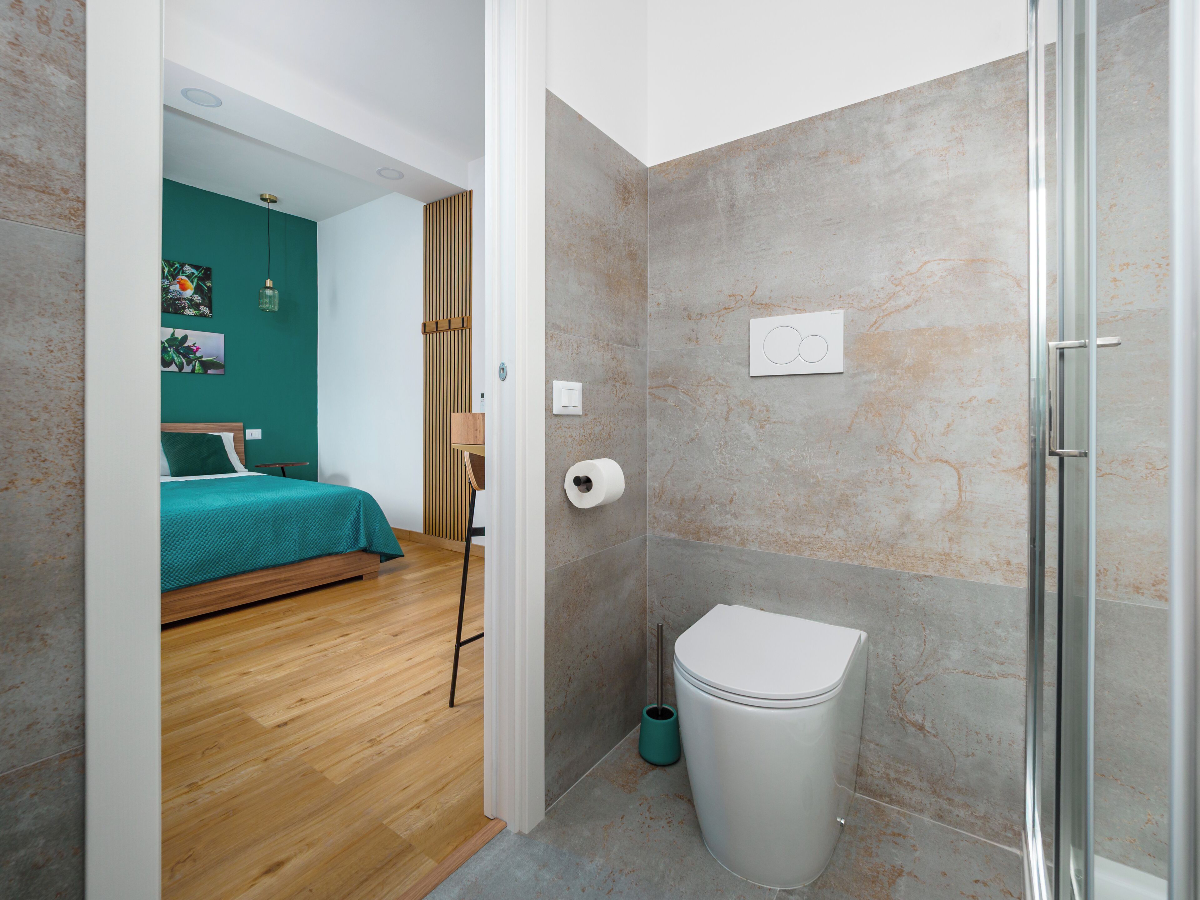 A bathroom with a toilet, a bidet, and a shower.
