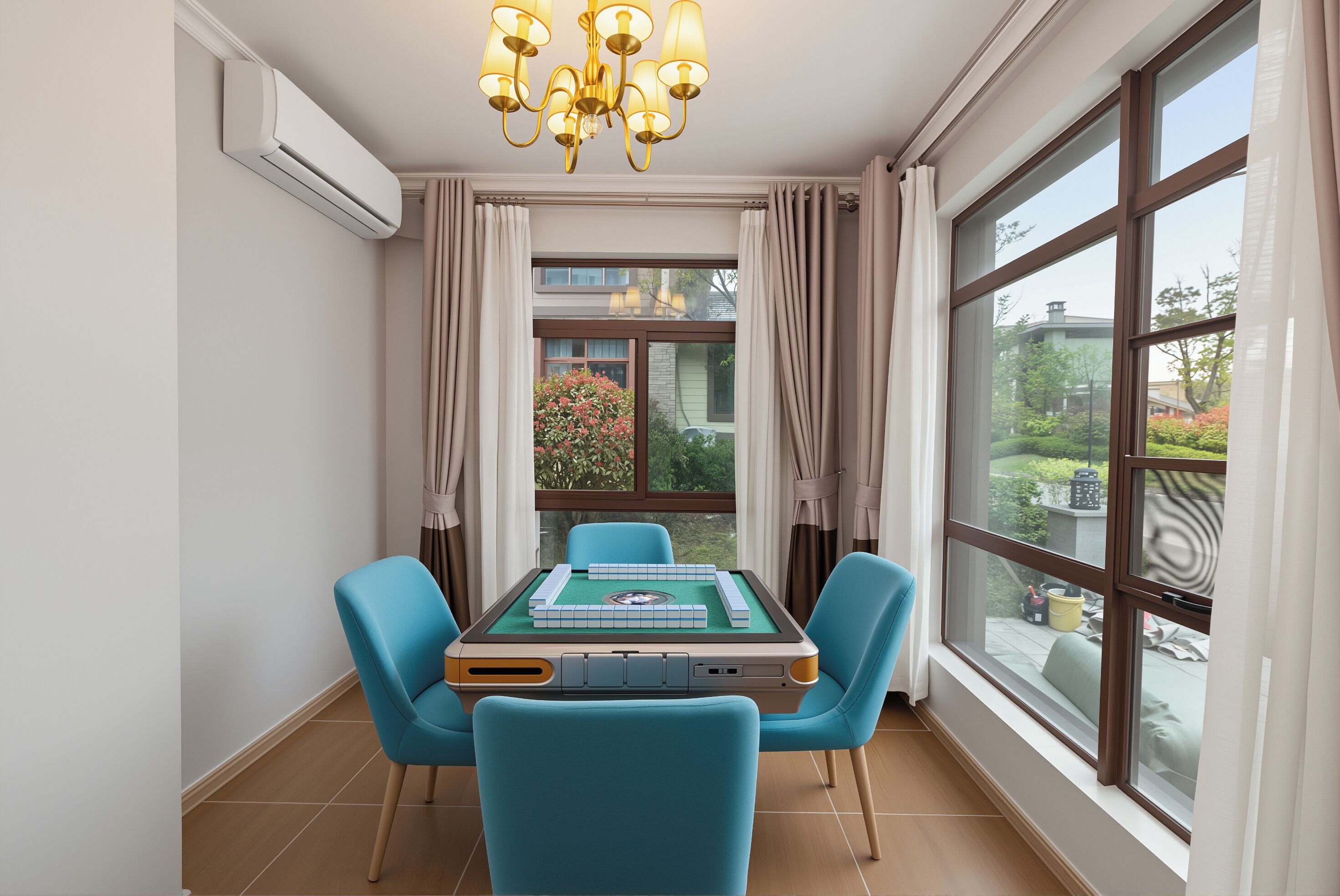 A room with a table, chairs, a chandelier, and large windows.