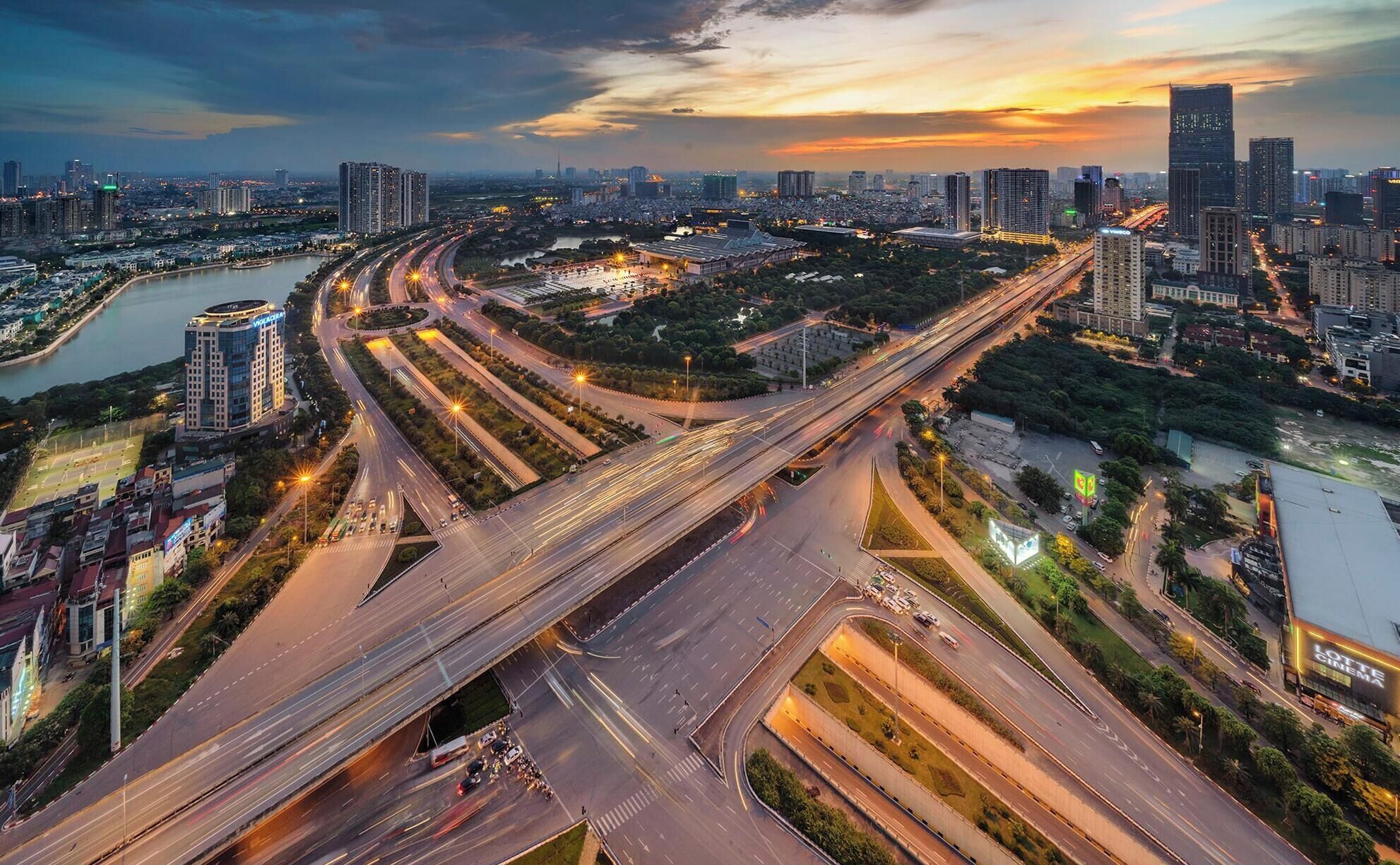 A complex highway interchange with multiple overpasses and a river.