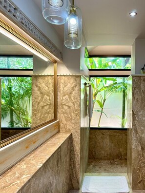 A bathroom with a large mirror, a shower with a glass door, and a view of greenery outside. - Azure Garden Villa, close to ChoengMon beach (Koh Samui)
