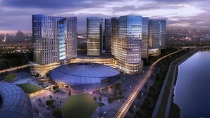 A modern architectural complex with multiple high-rise buildings, a central dome structure, and a waterfront view. - Zhangjiajie Merlot Crystal Hotel (Zhangjiajie)