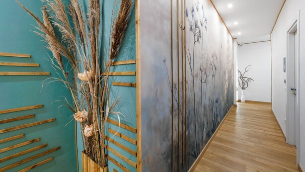 A hallway with wooden slats, a wall with abstract art, and a wooden floor. - Flowers Room – Nature-Inspired Elegance with a Private Balcony (Piano di Sorrento)