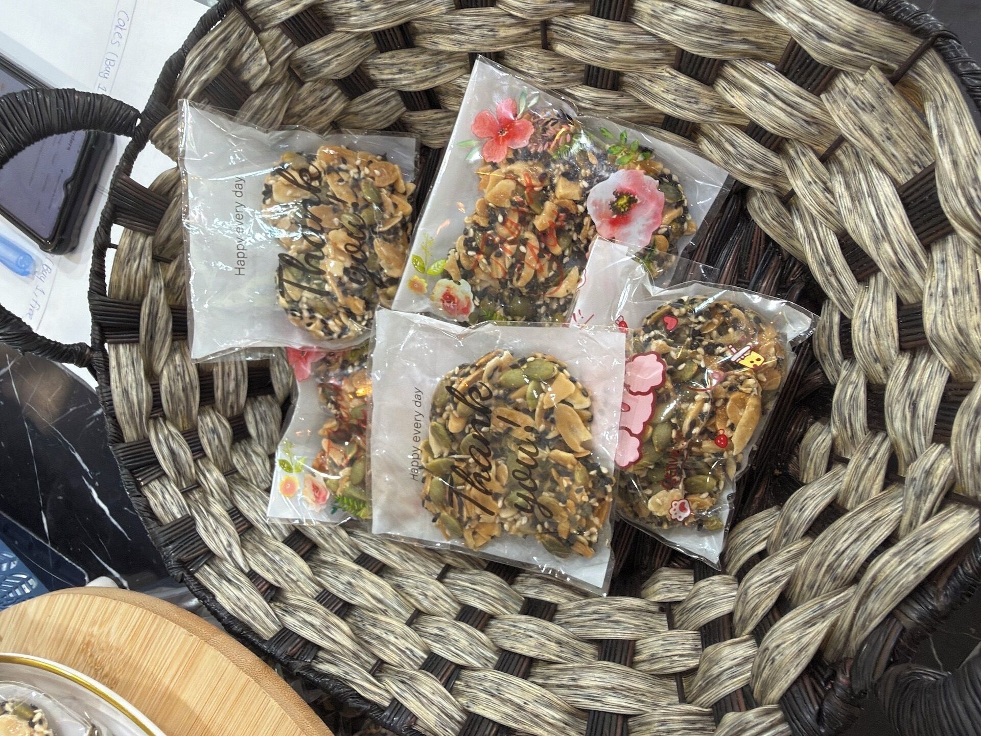 A woven basket containing four sealed packages with a floral design.