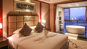 A hotel room with a large bed, a bathtub, and a balcony with a city view. - Avatar Valley Grand Hotel (Zhangjiajie)