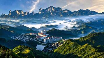 A resort with multiple buildings, a lake, and mountainous terrain.