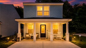 A two-story house with a porch, a front door, and a mailbox. - Cozy Gulfport Beach Home - Seahorse Harbor (Gulfport)