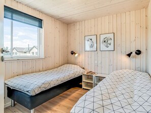 A room with two beds, a window, and two wall-mounted lamps. - 5 Star Holiday Home in Norre Nebel (Norre Nebel)