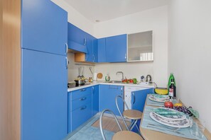 Standard Apartment, Multiple Bedrooms (Casetta Azzurra Capalbio) | Private kitchenette | Fridge, stovetop, electric kettle, cookware/dishes/utensils
