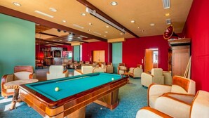 A pool table in a room with multiple chairs and a bar area. - Belvilla Heiderhof 1-bedroom Apartment (Obersteinebach)