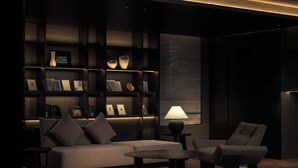 A modern living room with a sofa, armchair, coffee table, and bookshelves. - Atour Hotel Shanghai Yuyuan Yaduo  Bund (Shanghai)