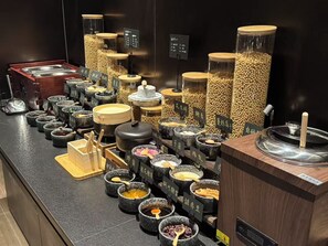 A buffet area with various food containers and utensils. - Atour Hotel Shanghai Yuyuan Yaduo  Bund (Shanghai)