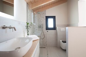 A modern bathroom with a large white sink, a shower, and a toilet. - Villa Katerina-Stylish 4DR villa with Sea View (Perigiali)