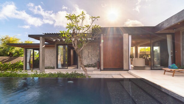 A modern house with a swimming pool, large windows, and a patio area. - Melasti Beach Villa (Ungasan)