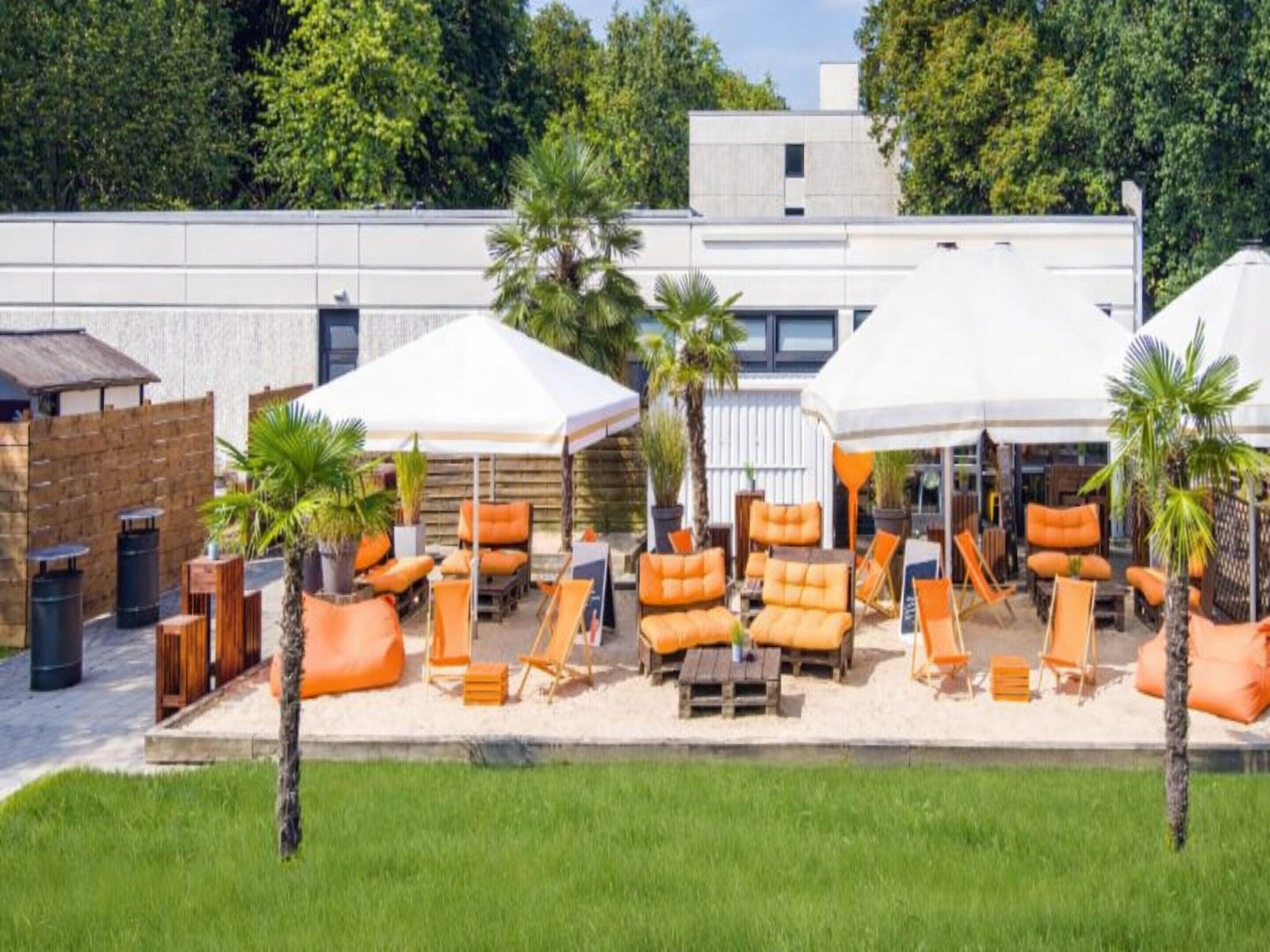 A rooftop lounge area with outdoor seating and umbrellas.