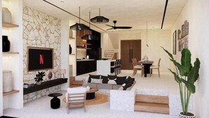 Una sala de estar moderna con una pared de piedra, un televisor de pantalla plana, un sofá, un comedor y un ventilador de techo.
