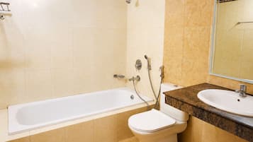 A bathroom with a bathtub, a toilet, and a sink.