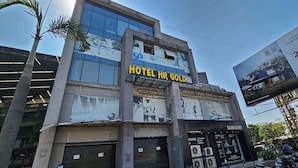 A multi-story building with a sign for 'HOTEL HR GOLD' and 'AVON THAI SPA'. - Hotel HR Gold (Ahmedabad)