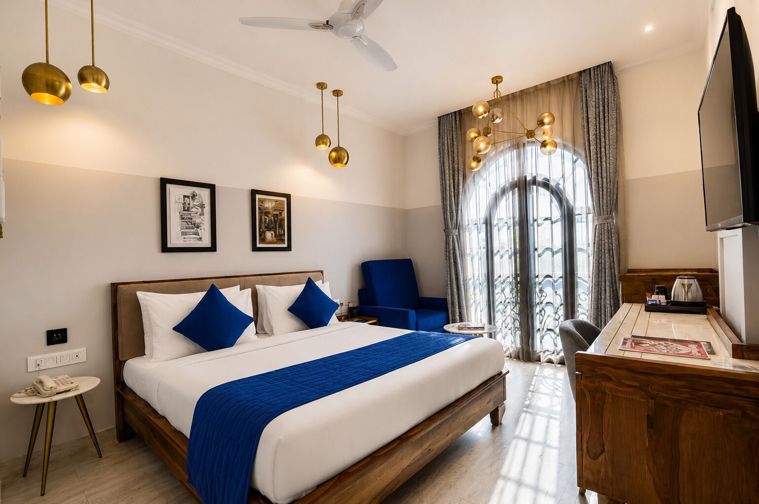 A hotel room with a bed, a desk, a chair, a TV, and a ceiling fan.