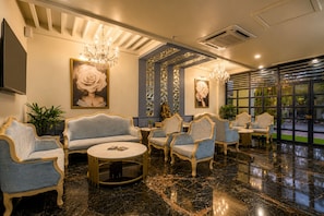A lobby with a marble floor, seating area with sofas and armchairs, chandeliers, and large windows. - Belmonte House, Udaipur (Udaipur)