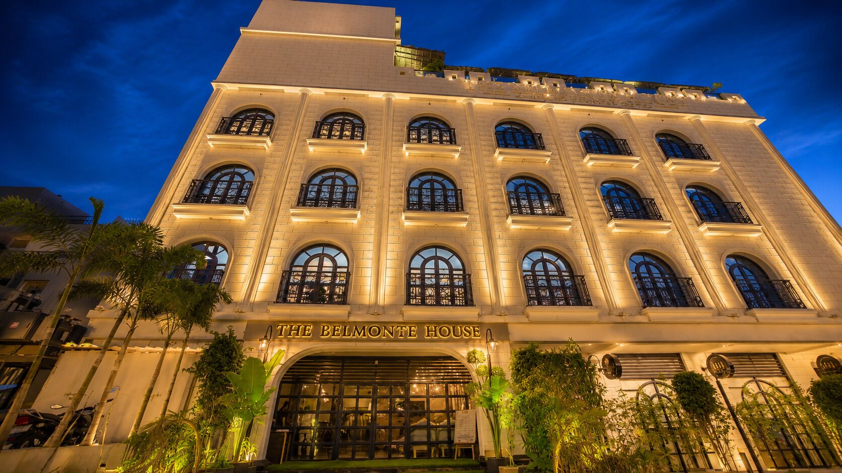 A large, multi-story building with arched windows and a prominent entrance.