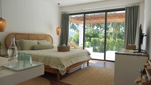 A bedroom with a bed, a desk, a TV, a window with a view of greenery, and a ceiling fan. - O3 Green 2b Garden Pool Villa and Unique Furniture (Ko Pha-ngan)