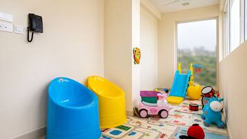 A child's play area with toys and a patterned play mat.