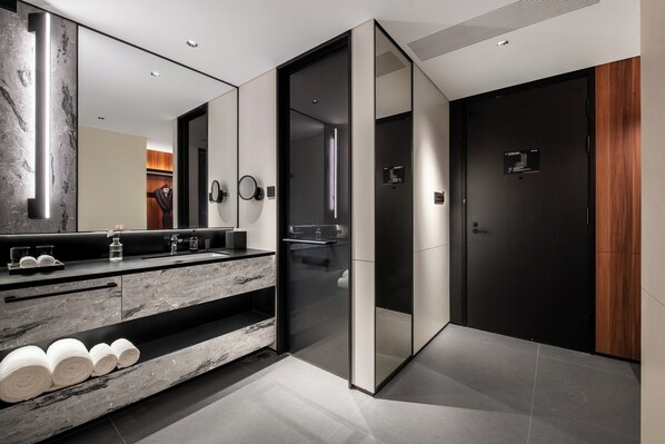 A modern bathroom with a marble vanity, a glass shower enclosure, and a dark door. - Intercity Hotel Chengdu Kuanzhai Alley (Chengdu)