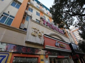 A multi-story building with a prominent sign for a hotel. - 7 (Nanchang)
