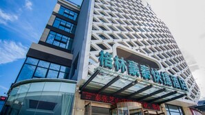 A modern hotel with a distinctive geometric facade and large glass windows. - Greentree (Nantong)