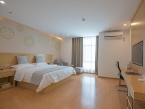 A modern hotel room with a large bed, bedside tables, a desk with a chair, a TV, and a window with curtains. - Greentree Inn Hotel (Hefei)