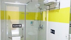 A bathroom with a glass shower enclosure, a towel rack, and a sink. - 7 Days Hotel Mafangshan Subway Station of Wuhan Jiedaokou University of Technology (Wuhan)