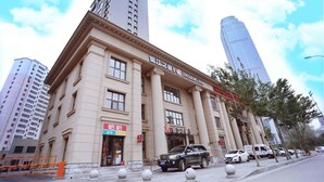 A hotel with a classical facade, multiple windows, and a prominent sign. - Jinjiang Inn Select (Shenyang)