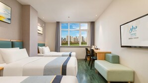 A hotel room with two beds, a desk, a chair, and a view of a cityscape. - Jinjiang Inn Select (Shenyang)