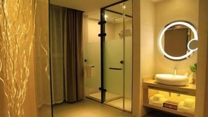 A modern bathroom with a glass shower enclosure, a round mirror with lighting, and a white sink. - Lavande Hotels·tianshui Gangu Yicheng Square (Tianshui)