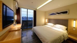 A hotel room with a large bed, a desk, a chair, a TV, and a window with a view. - City Comfort Inn Shenzhen International Exhibition Center Tangwei Metro Station (Shenzhen)