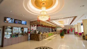 A hotel lobby with a reception desk, a large chandelier, and a patterned floor design. - Greentree Alliance Yancheng Sheyang County Xixin Temple Hotel (Yancheng)