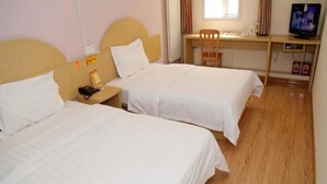 A hotel room with two beds, a desk, a chair, a television, and a window. - 7days Inn Chain Hotel (Beijing)