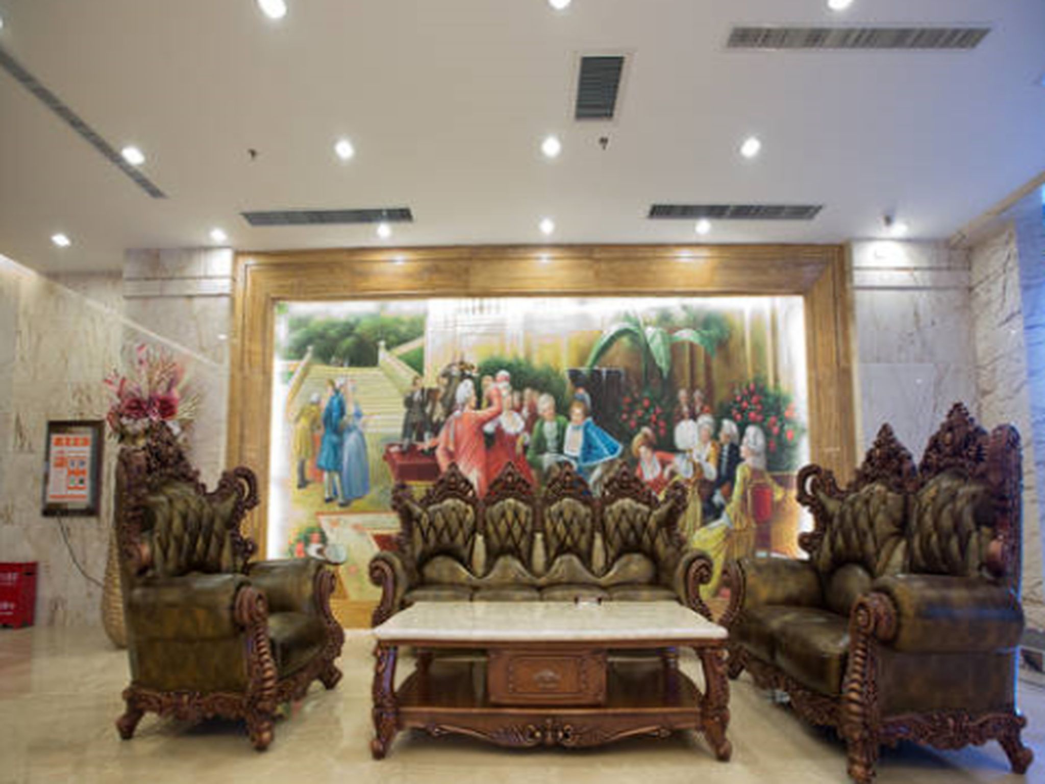 A lobby with a large mural, ornate furniture, and a marble floor.