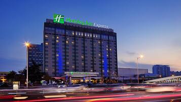 A Holiday Inn Express hotel with a modern design, multiple floors, and a prominent sign.