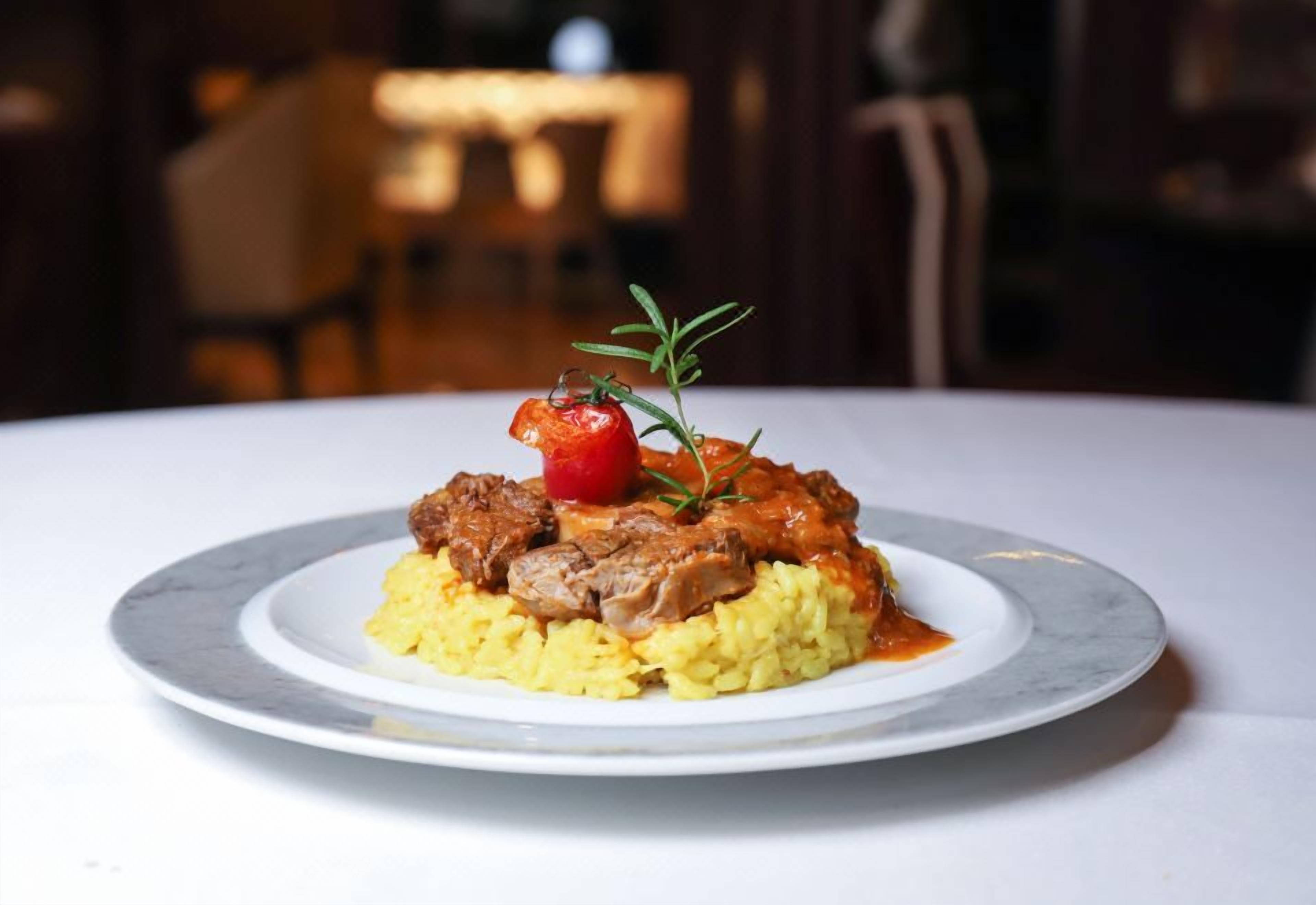 A plate of food with a garnish on a white plate.
