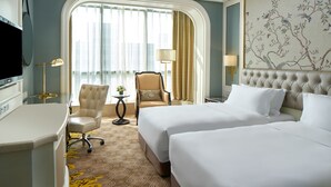 A hotel room with a bed, a desk, a chair, a TV, and a window with curtains. - Crowne Plaza Zhengzhou by IHG (Zhengzhou)