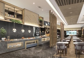 A modern restaurant interior with a buffet counter, seating area, and a large screen. - Holiday Inn Foshan Nanhai Central by IHG (Foshan)
