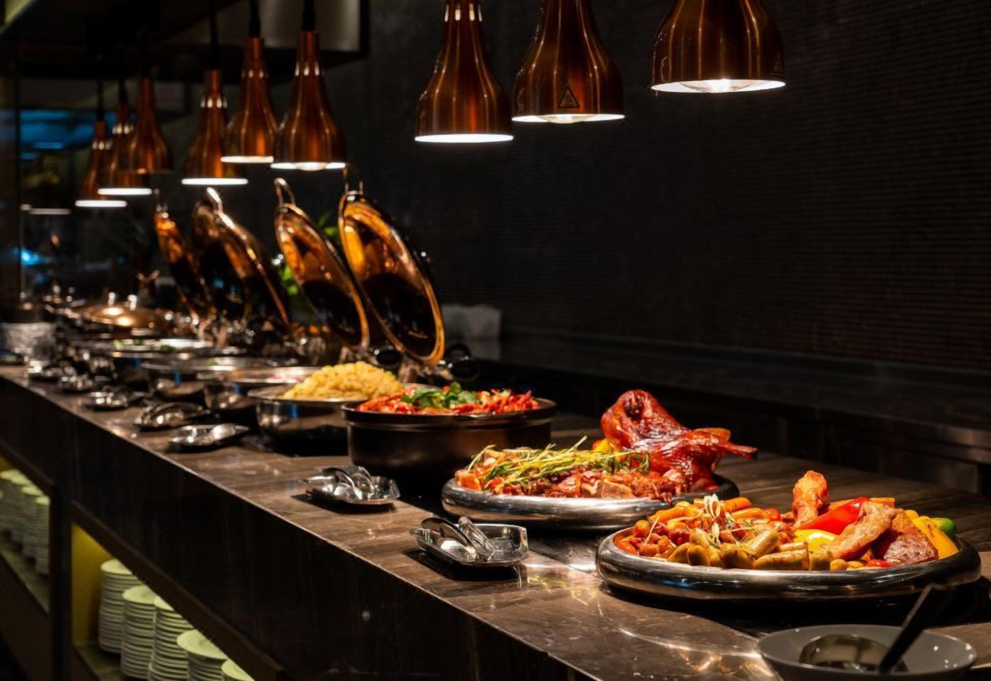 A buffet with various dishes and a long counter.