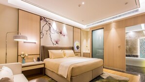 A modern hotel room with a large bed, bedside tables, a desk, and a seating area. - Magnotel Yingda Road, Baoji (Baoji)
