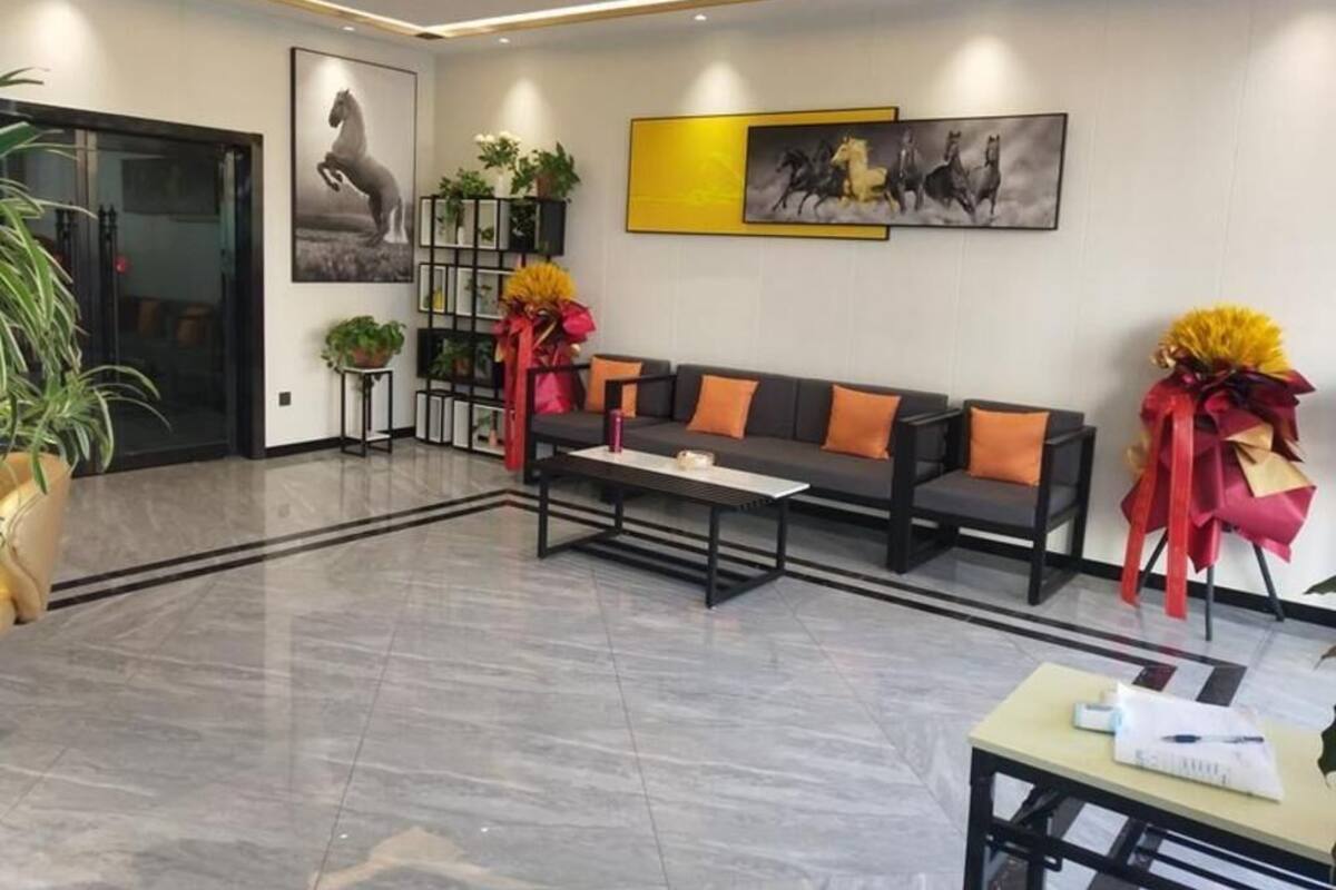 Un vestíbulo moderno con sofá, mesa de centro y plantas decorativas.