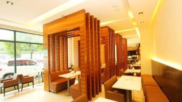Interior moderno de restaurante com divisórias de madeira, disposição de assentos e vista para o exterior.