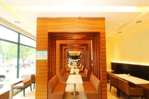 A modern restaurant with a central dining area, booths, and a counter. - Jinjiang Inn Select (Wuhan)